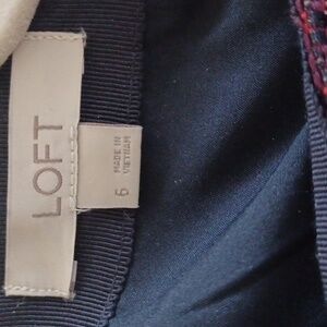 A Loft size 6 mini skirt. It is burgundy with navy and cream  colors.